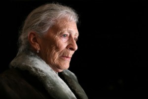 Portrait of a senior woman contemplating. Isolated on black background.