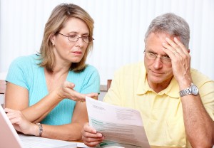 Senior couple working with laptop at home