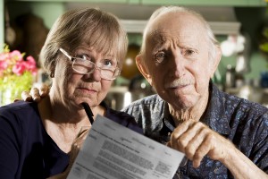 Elder Couple at Home with Bills